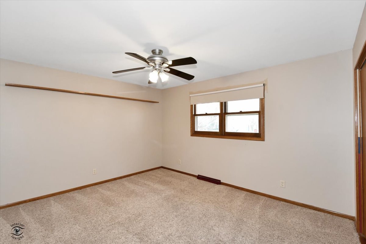 616 Northgate Road New Lenox, IL 60451 - Photo 20 of 34 an empty room with a window and a fan
