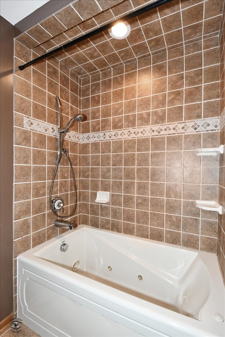 616 Northgate Road New Lenox, IL 60451 - Photo 25 of 34 a bathroom with a bathtub and a window