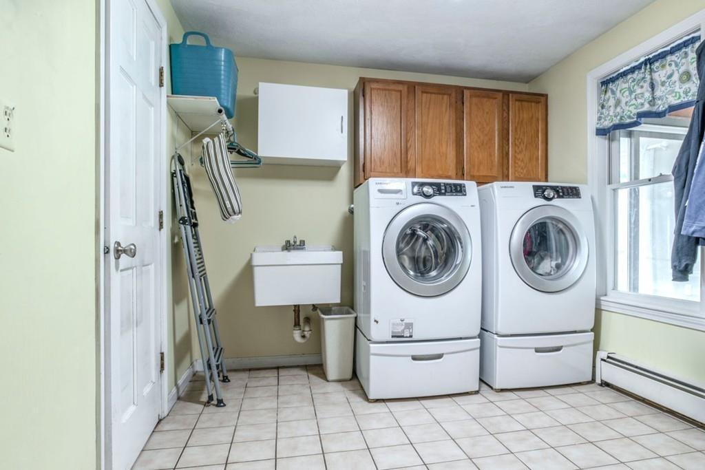 89 Shadow Oak Drive Sudbury, MA 01776 - Photo 16 of 31 a utility room with dryer washer and a view of living room