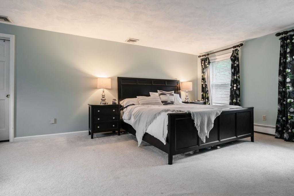 89 Shadow Oak Drive Sudbury, MA 01776 - Photo 18 of 31 a bedroom with a bed and a night stand