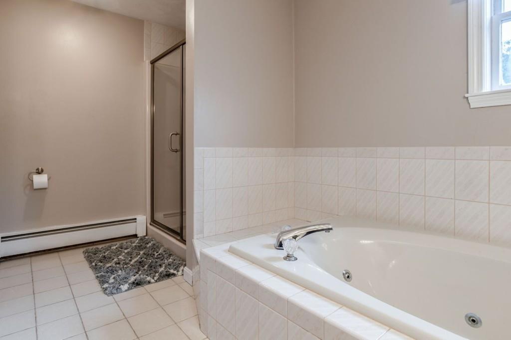 89 Shadow Oak Drive Sudbury, MA 01776 - Photo 20 of 31 a bathroom with a bathtub and shower