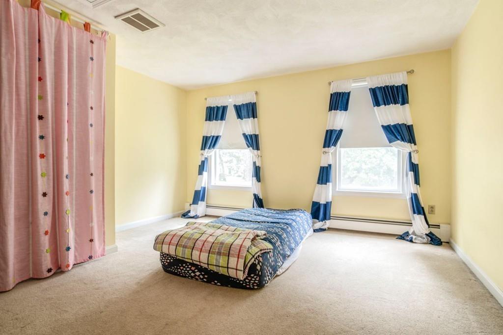 89 Shadow Oak Drive Sudbury, MA 01776 - Photo 22 of 31 a bedroom with a bed and wooden floor