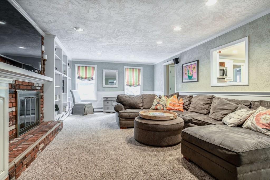 89 Shadow Oak Drive Sudbury, MA 01776 - Photo 6 of 31 a living room with furniture and a fireplace