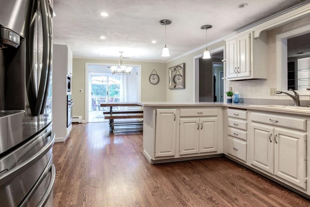 89 Shadow Oak Drive Sudbury, MA 01776 - Photo 7 of 31 a kitchen with white cabinets and stainless steel appliances