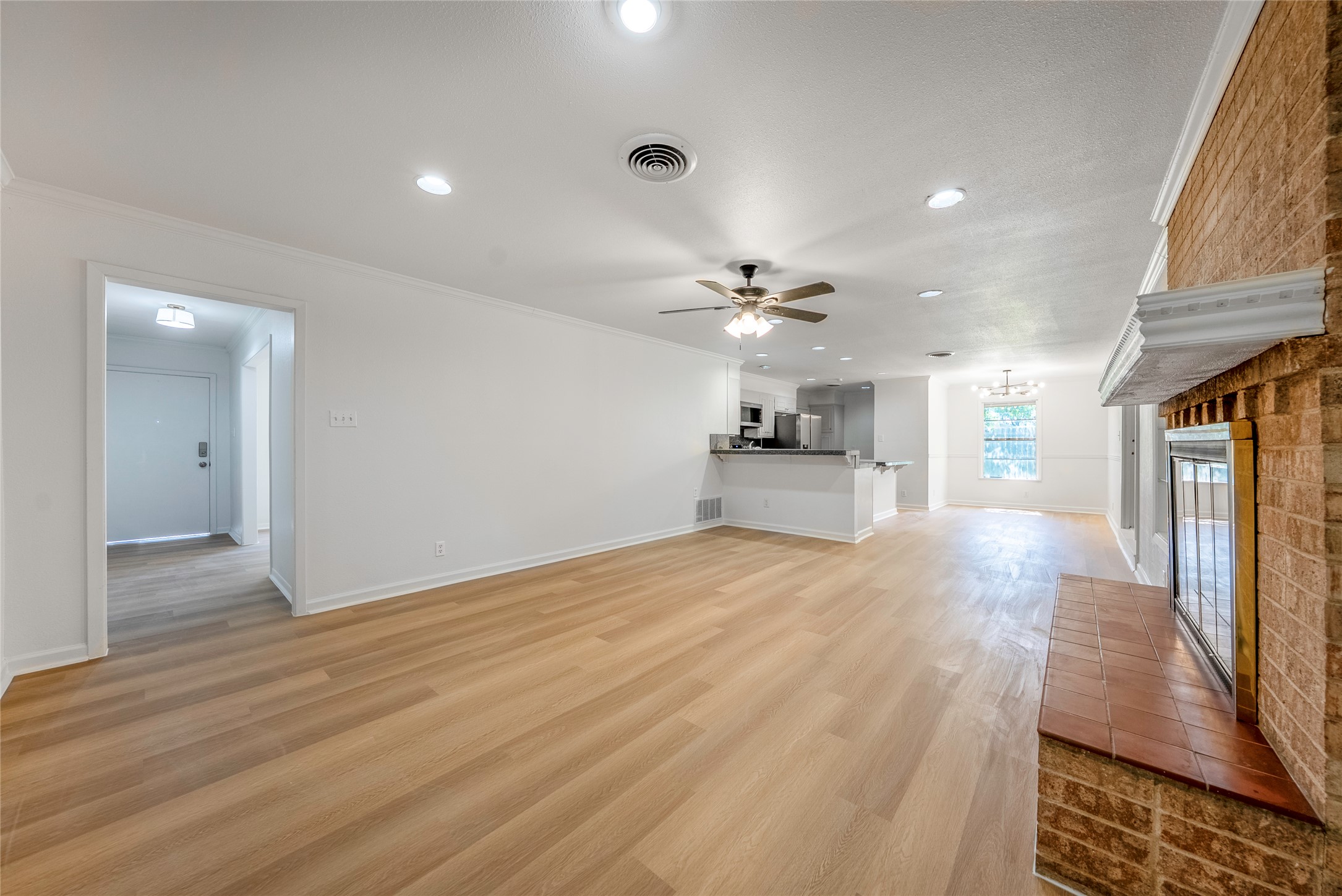 807 Country Club Road Georgetown, TX 78628 - Photo 5 of 28 a view of empty room with wooden floor and fan