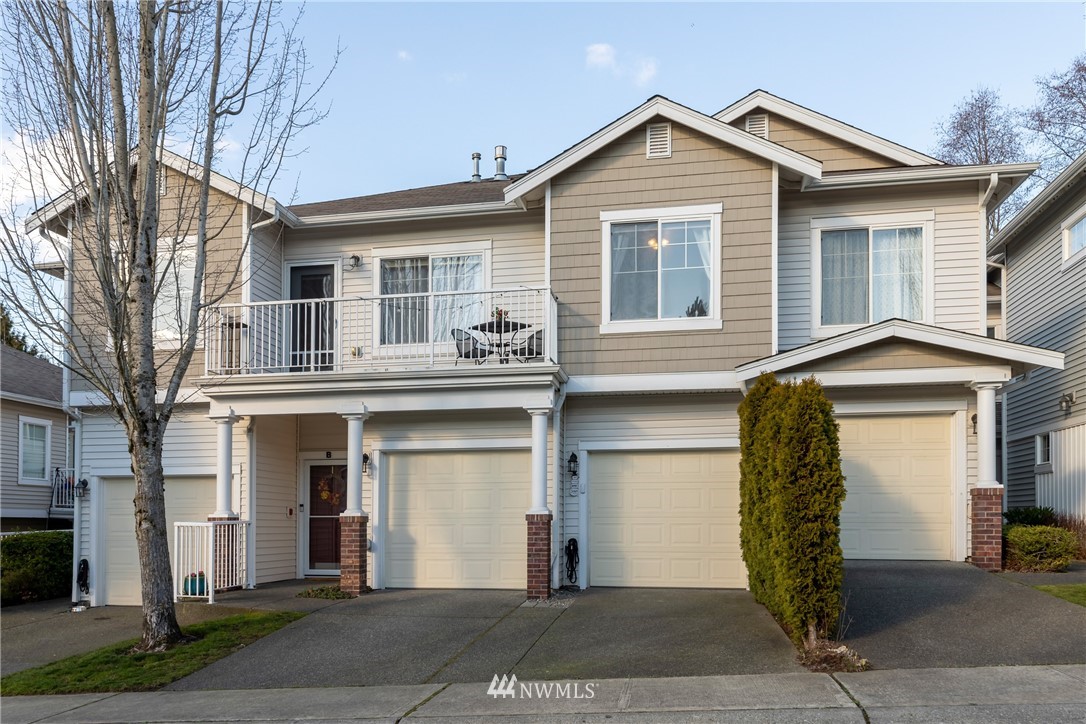 214 South 48th Street, Unit 45B Renton, WA 98055 - Photo 1 of 30 a front view of a house with a yard and garage