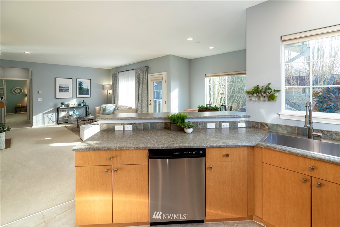 214 South 48th Street, Unit 45B Renton, WA 98055 - Photo 11 of 30 a kitchen with granite countertop a sink and a white stainless steel appliances