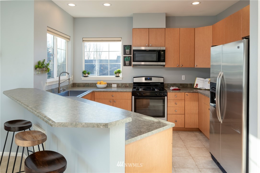 214 South 48th Street, Unit 45B Renton, WA 98055 - Photo 8 of 30 a kitchen with a sink a stove and refrigerator