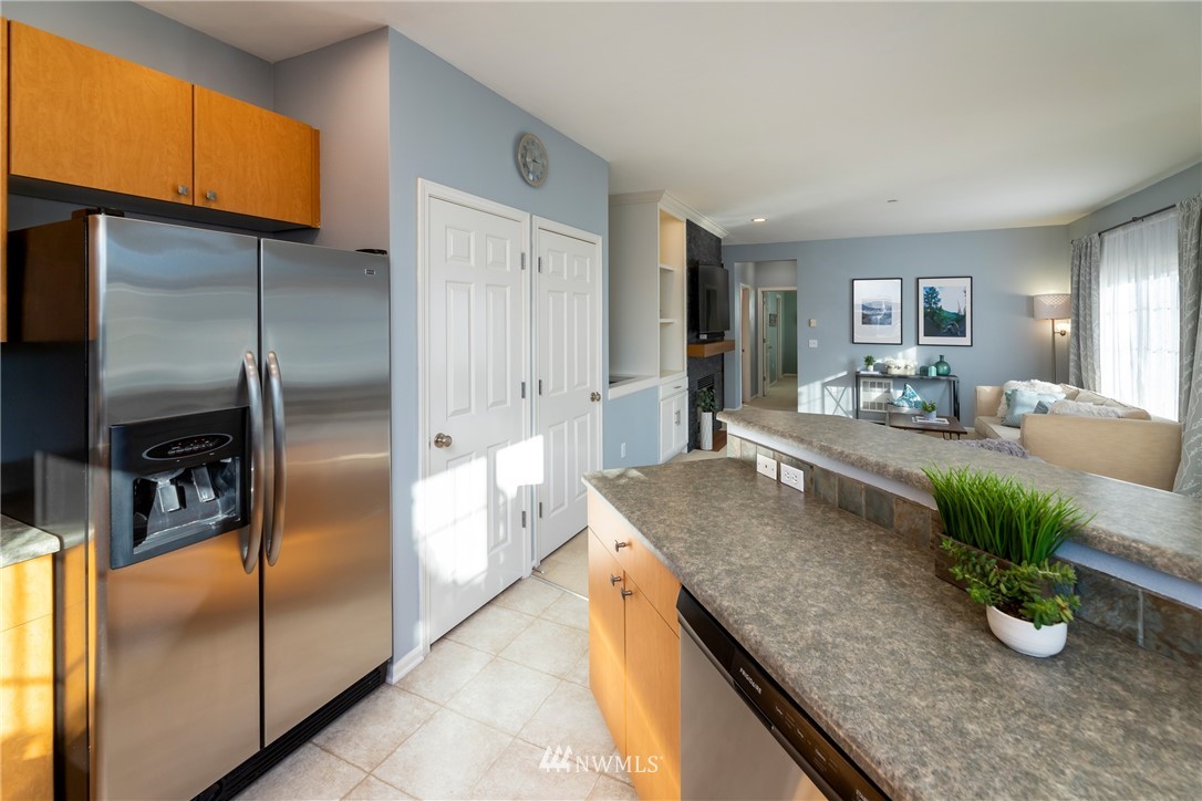 214 South 48th Street, Unit 45B Renton, WA 98055 - Photo 9 of 30 a kitchen with counter top space cabinets and stainless steel appliances