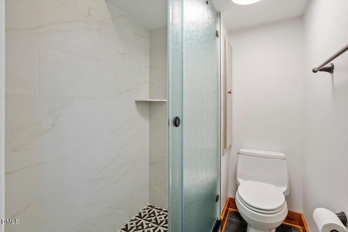 4805 Rembert Drive Raleigh, NC 27612 - Photo 27 of 45 a white toilet sitting next to a shower