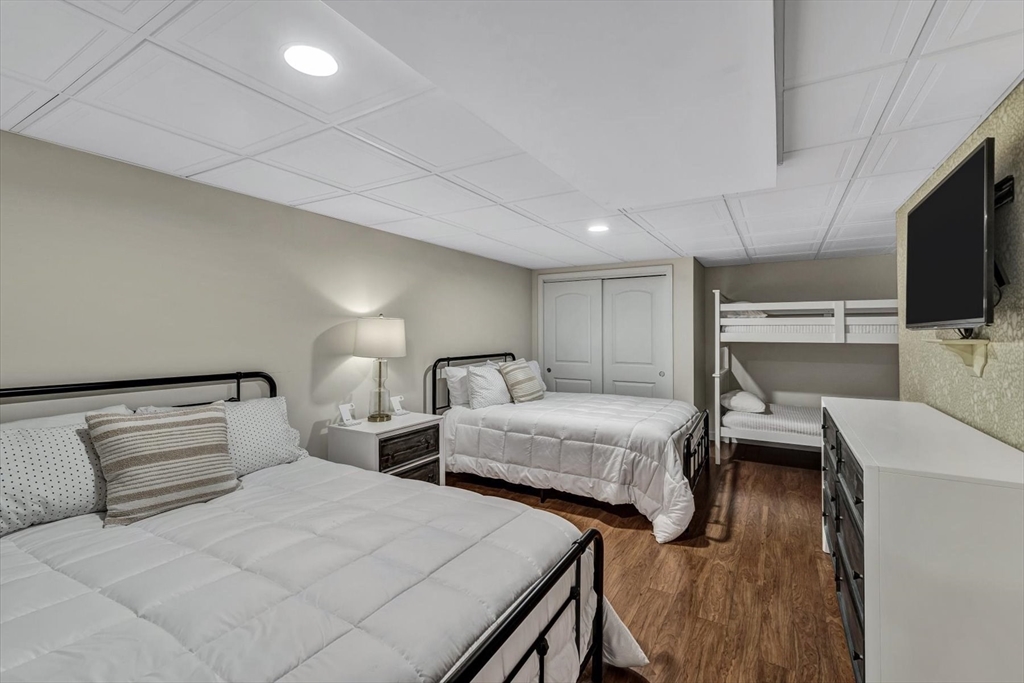 97 Fells Pond Road Mashpee, MA 02649 - Photo 38 of 40 a bedroom with two beds and a flat screen tv