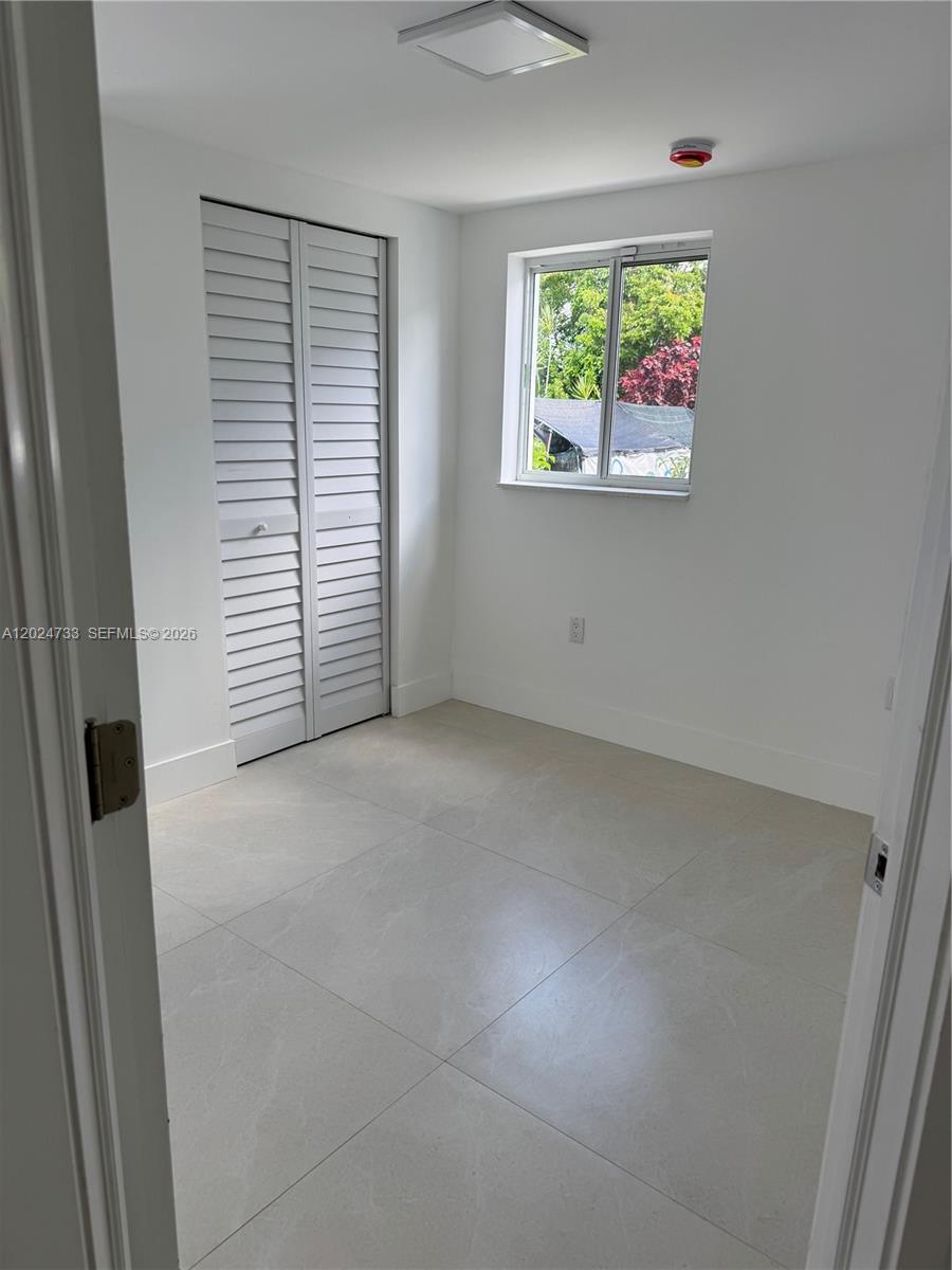 3305 Southwest 28th Street, Unit 3305 Miami, FL 33133 - Photo 17 of 17 an empty room with windows
