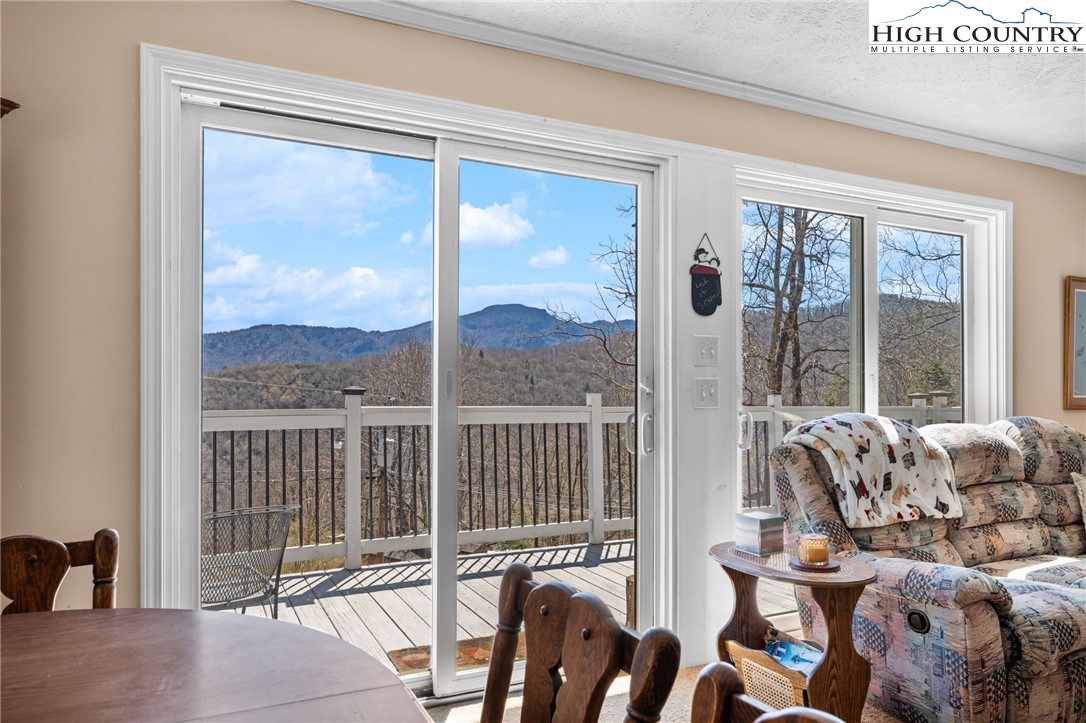 431 Cliffside Lane Seven Devils, NC 28604 - Photo 11 of 46 a view of a balcony with furniture and floor to ceiling window