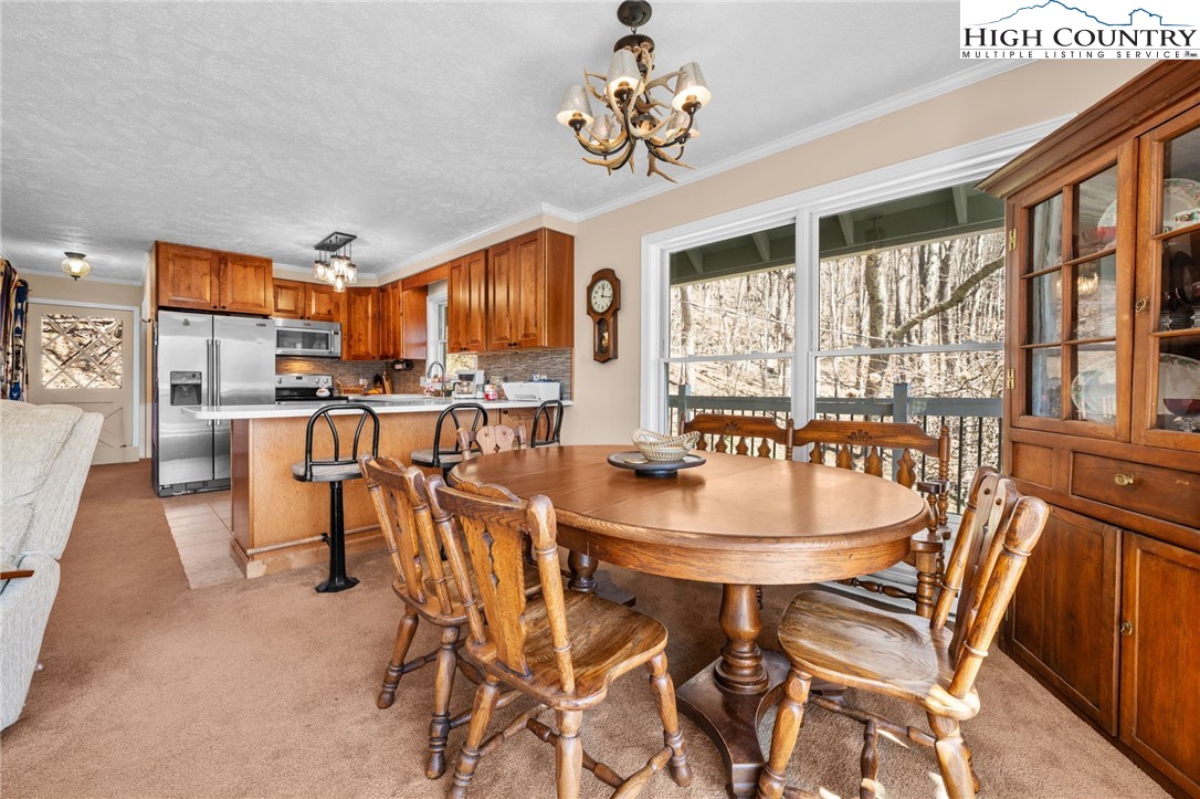 431 Cliffside Lane Seven Devils, NC 28604 - Photo 12 of 46 a view of a dining room with furniture window and outside view