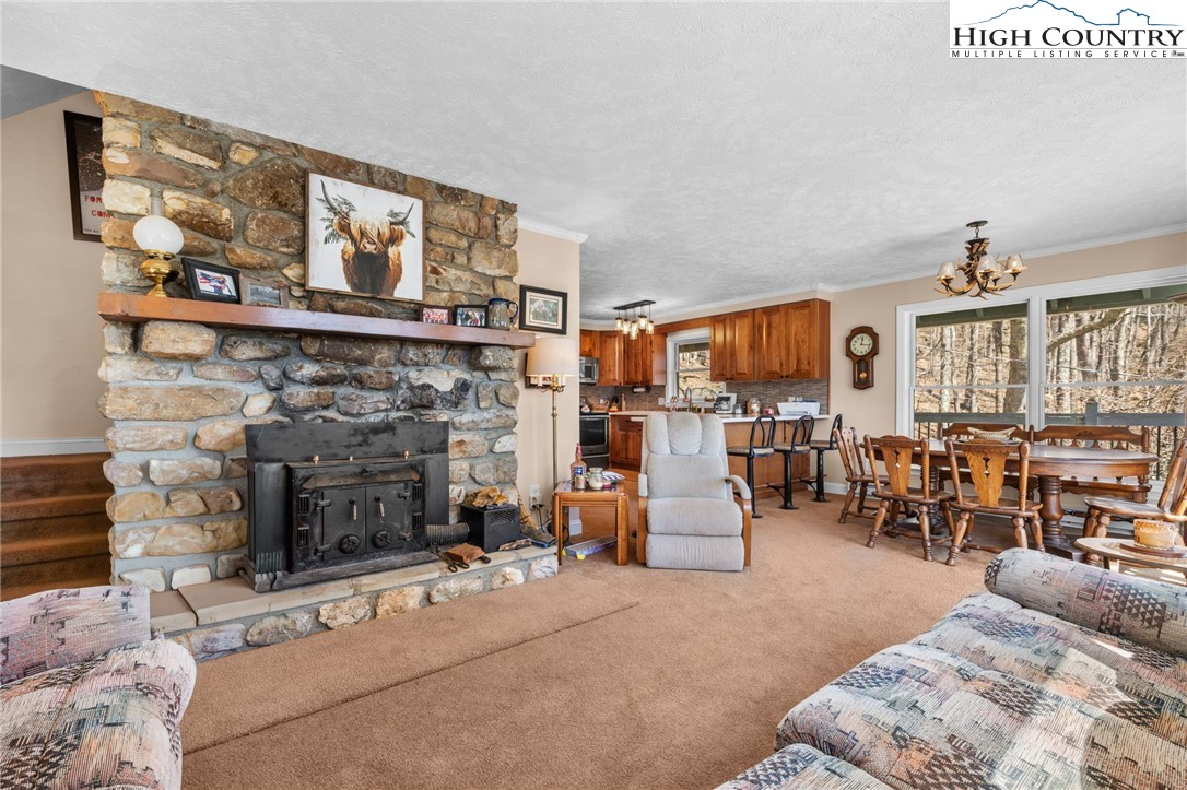 431 Cliffside Lane Seven Devils, NC 28604 - Photo 13 of 46 a living room with furniture and a fireplace