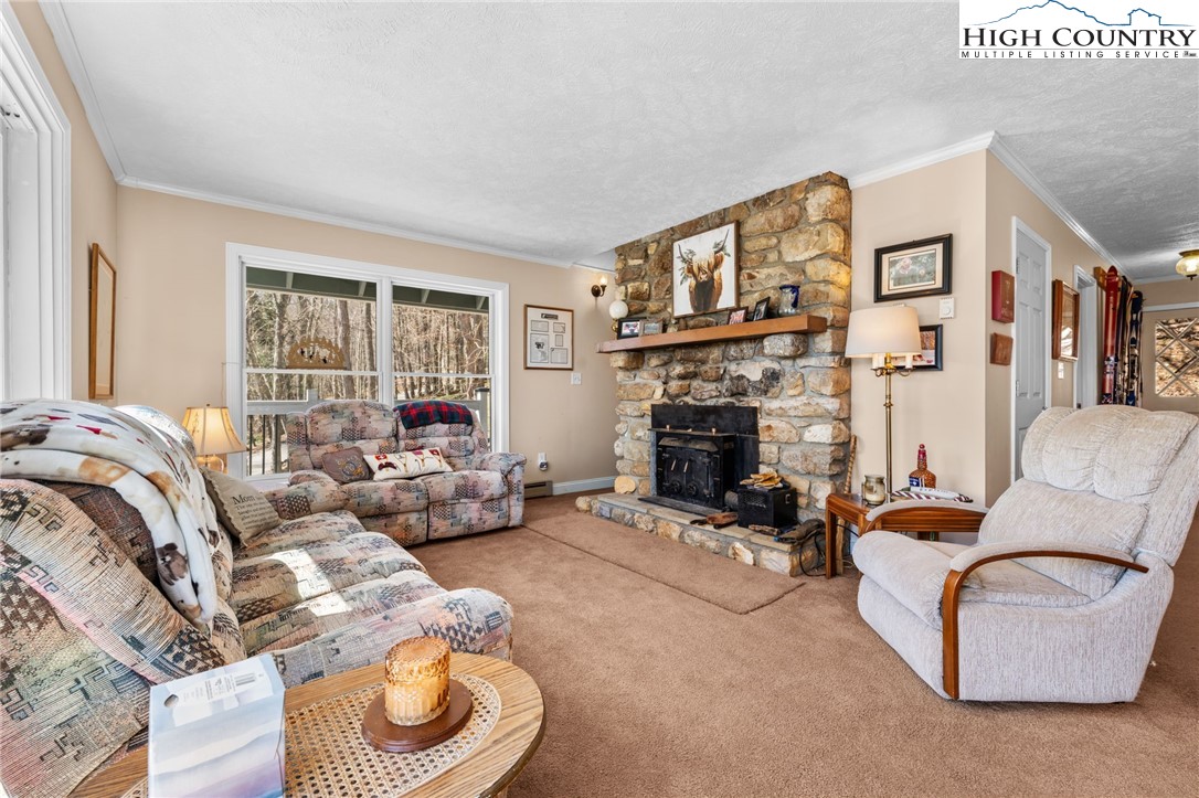 431 Cliffside Lane Seven Devils, NC 28604 - Photo 14 of 46 a living room with furniture and a fireplace