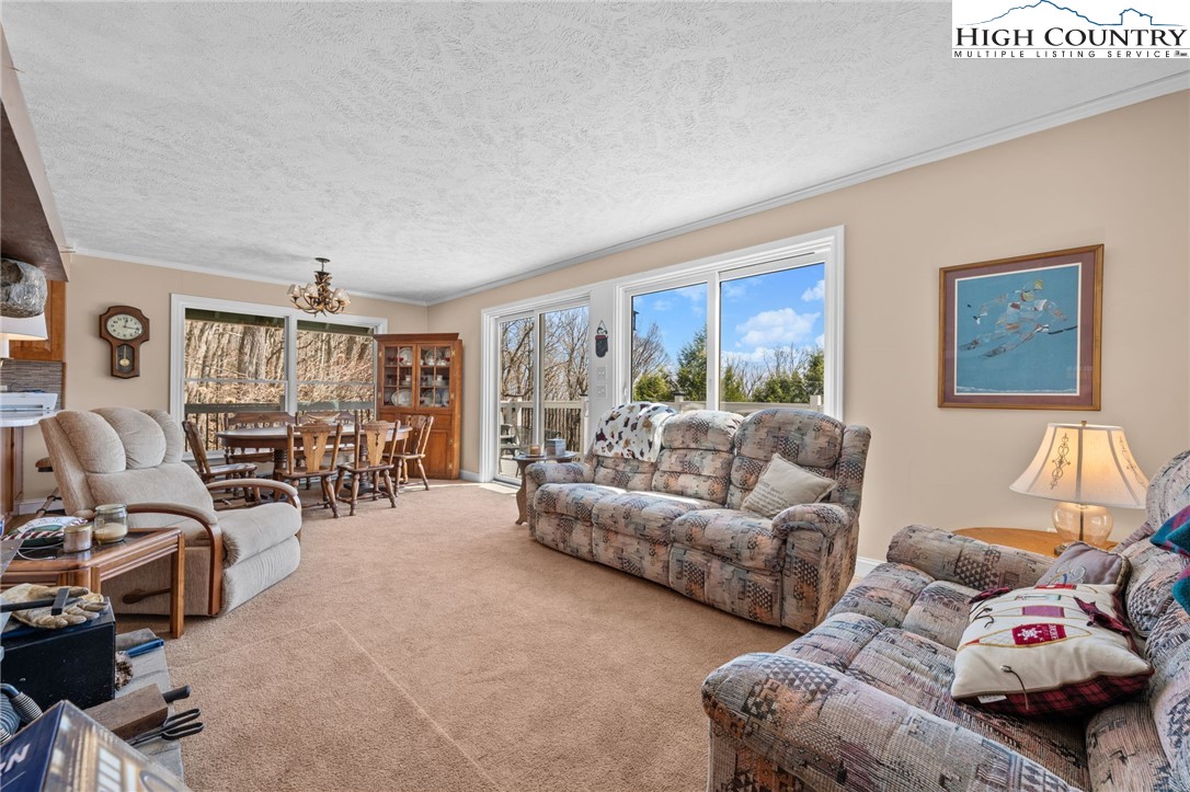 431 Cliffside Lane Seven Devils, NC 28604 - Photo 15 of 46 a living room with furniture and a large window