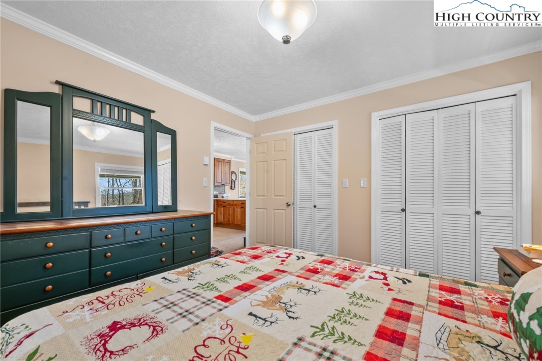 431 Cliffside Lane Seven Devils, NC 28604 - Photo 17 of 46 a bedroom with a bed and a dresser