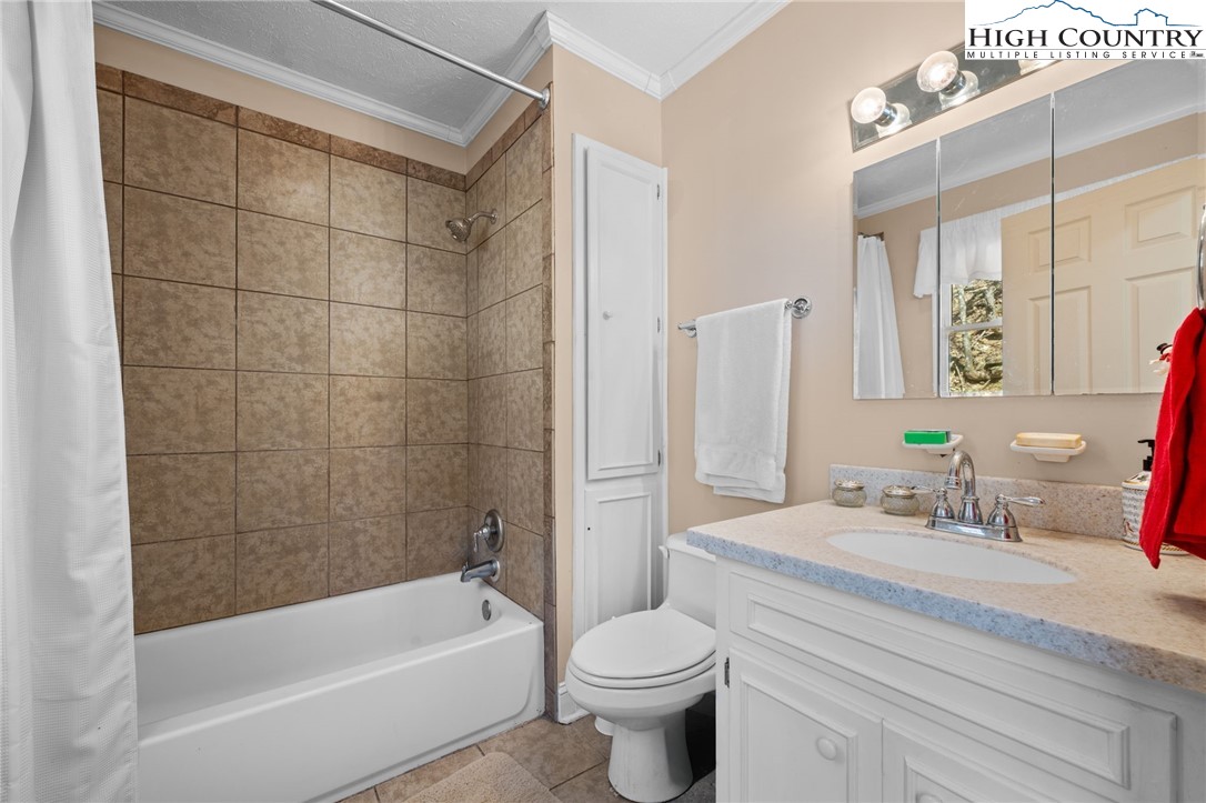 431 Cliffside Lane Seven Devils, NC 28604 - Photo 18 of 46 a bathroom with a sink toilet and shower