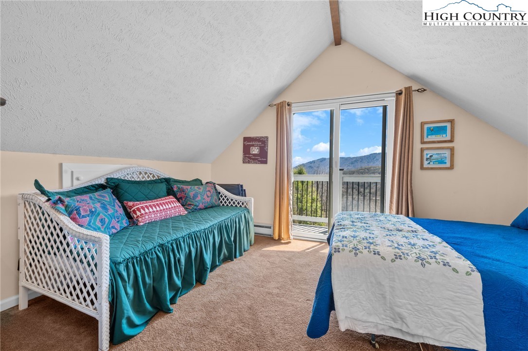 431 Cliffside Lane Seven Devils, NC 28604 - Photo 19 of 46 a bedroom with a bed and a large window