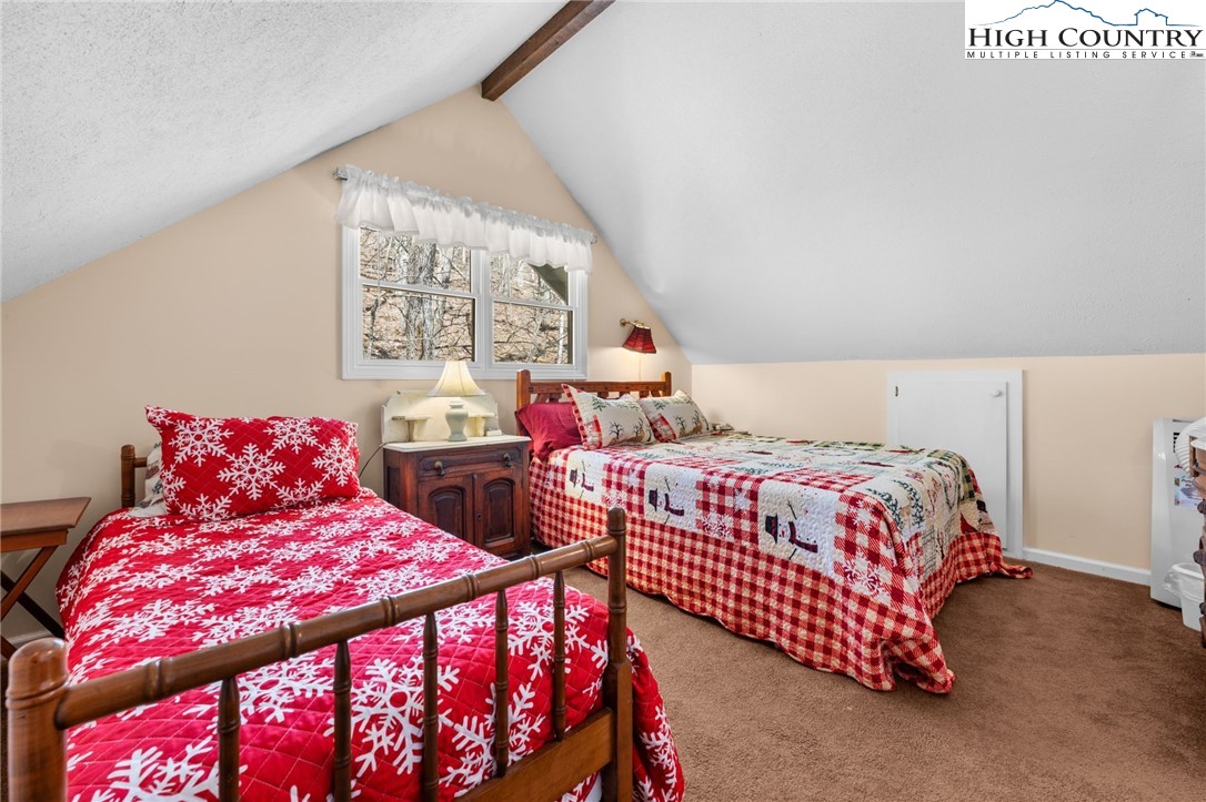 431 Cliffside Lane Seven Devils, NC 28604 - Photo 22 of 46 a bedroom with two beds and a large window