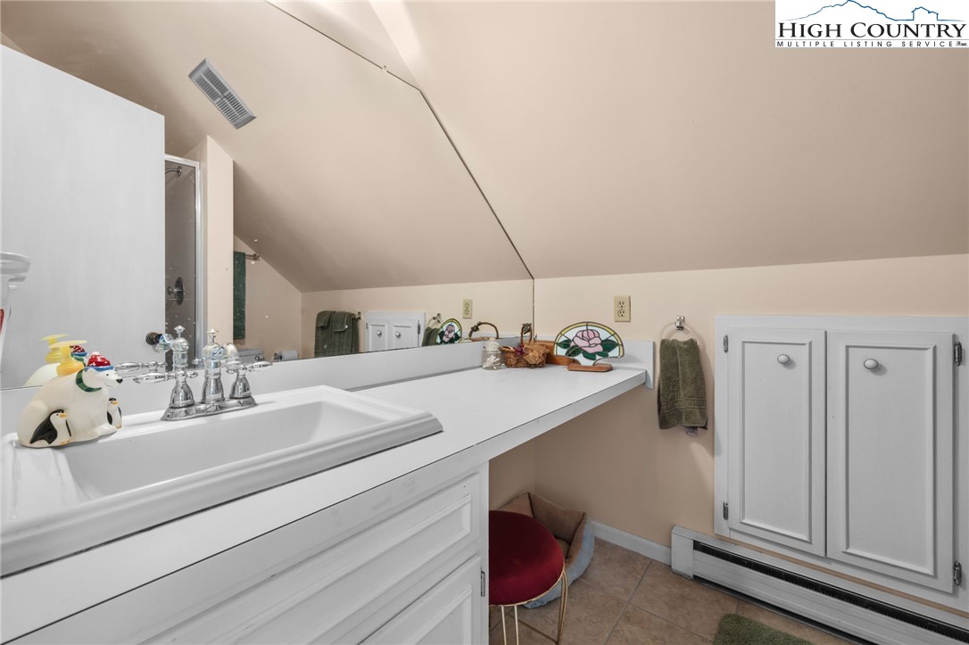 431 Cliffside Lane Seven Devils, NC 28604 - Photo 23 of 46 a bathroom with a sink and a mirror