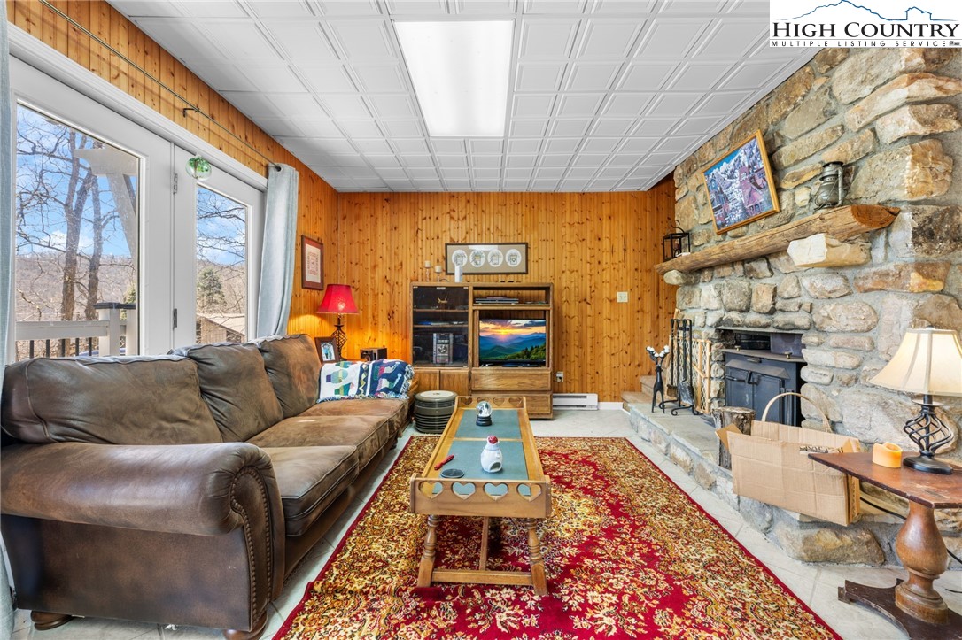 431 Cliffside Lane Seven Devils, NC 28604 - Photo 24 of 46 a living room with furniture and a flat screen tv