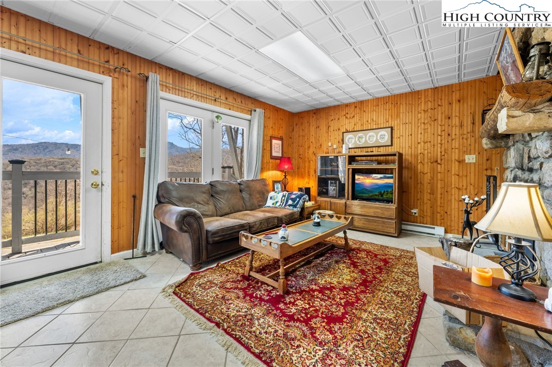 431 Cliffside Lane Seven Devils, NC 28604 - Photo 25 of 46 a living room with furniture a rug and a window