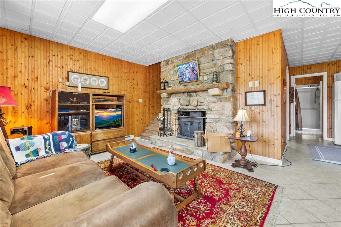 431 Cliffside Lane Seven Devils, NC 28604 - Photo 26 of 46 a living room with fireplace furniture and a flat screen tv