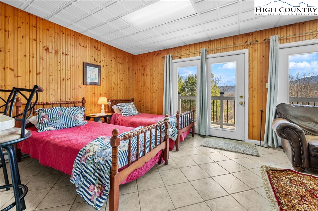 431 Cliffside Lane Seven Devils, NC 28604 - Photo 27 of 46 a bedroom with a bed a table and chair