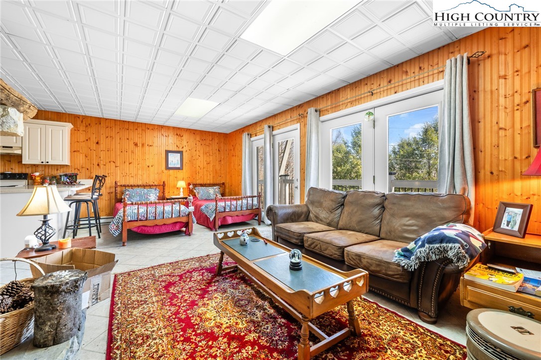 431 Cliffside Lane Seven Devils, NC 28604 - Photo 28 of 46 a living room with furniture and a large window
