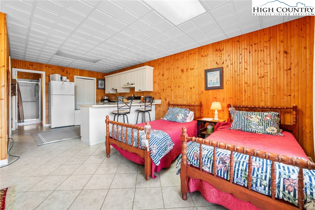 431 Cliffside Lane Seven Devils, NC 28604 - Photo 29 of 46 a bedroom with furniture and a large window