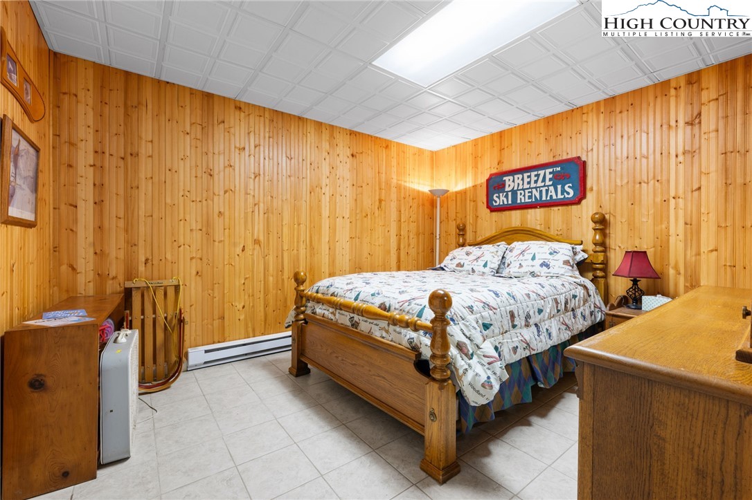 431 Cliffside Lane Seven Devils, NC 28604 - Photo 33 of 46 a bed sitting in a room next to a window