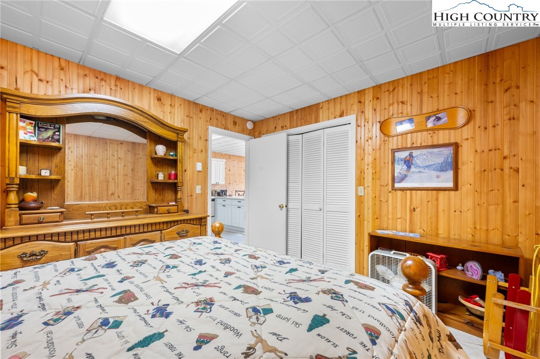 431 Cliffside Lane Seven Devils, NC 28604 - Photo 34 of 46 a bedroom with a bed and a large window