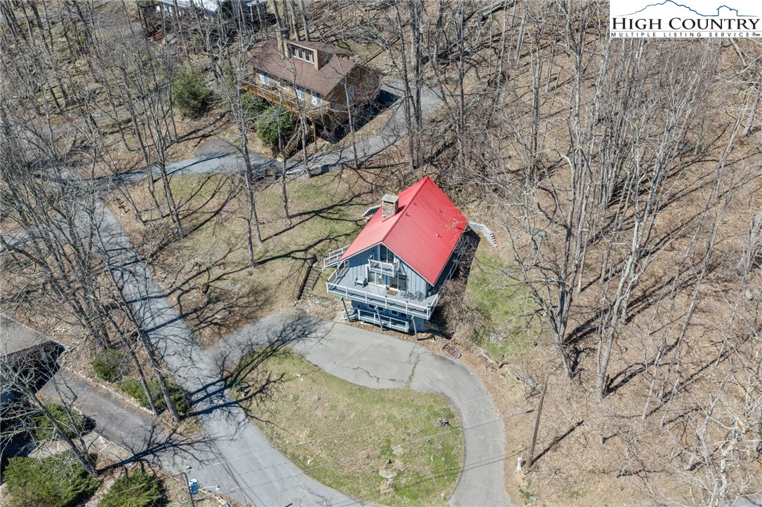 431 Cliffside Lane Seven Devils, NC 28604 - Photo 43 of 46 an aerial view of a house with swimming pool and red chairs