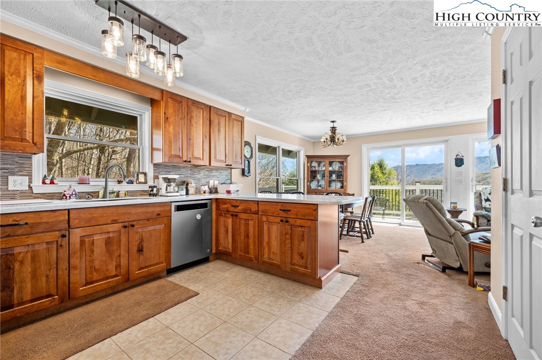 431 Cliffside Lane Seven Devils, NC 28604 - Photo 8 of 46 a large kitchen with kitchen island granite countertop a large counter top space and stainless steel appliances