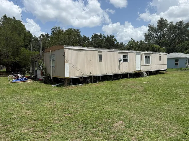 a view of a white house with a yard