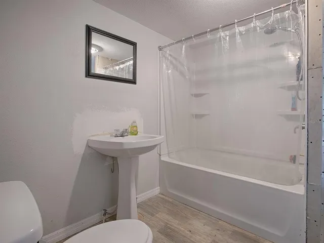 a bathroom with a sink a toilet and a bathtub