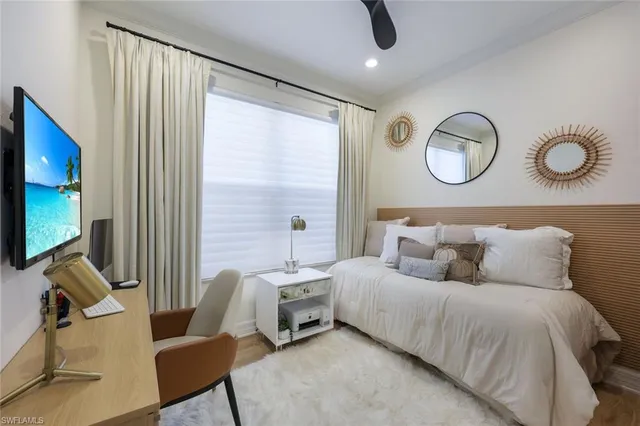 a bedroom with a bed and flat screen tv