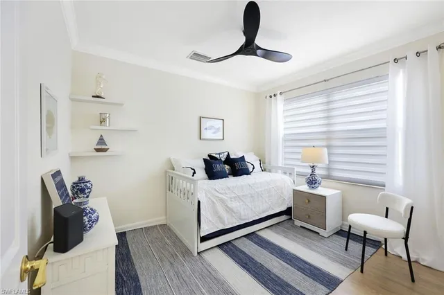 a bedroom with a bed and a chair