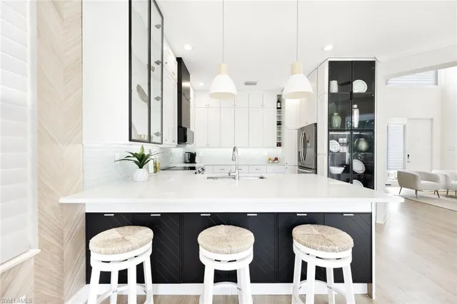 a bathroom with a granite countertop sink and a large mirror