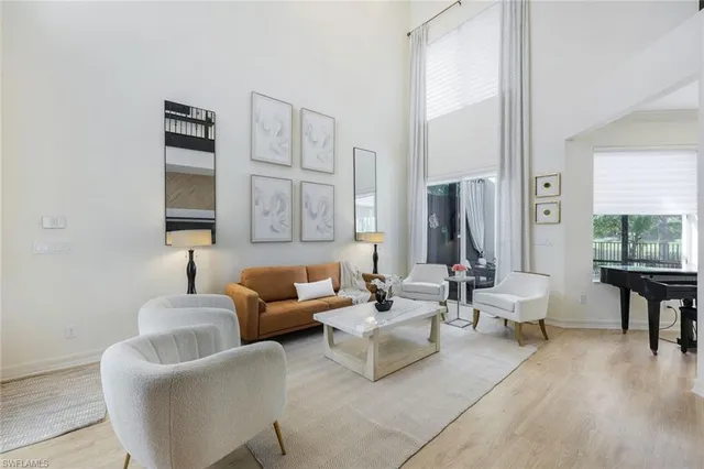 a living room with furniture and a lamp