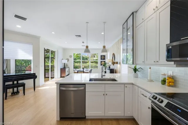 a kitchen with a sink appliances and a counter top space