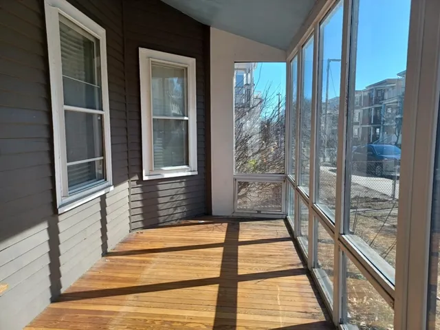 a view of a balcony with a floor to ceiling window