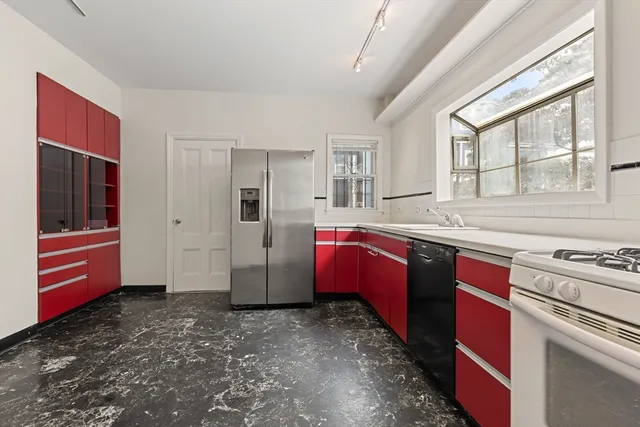 a kitchen with stainless steel appliances granite countertop a stove a sink and a refrigerator