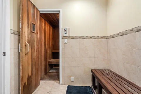 a view of walk in closet with clothes