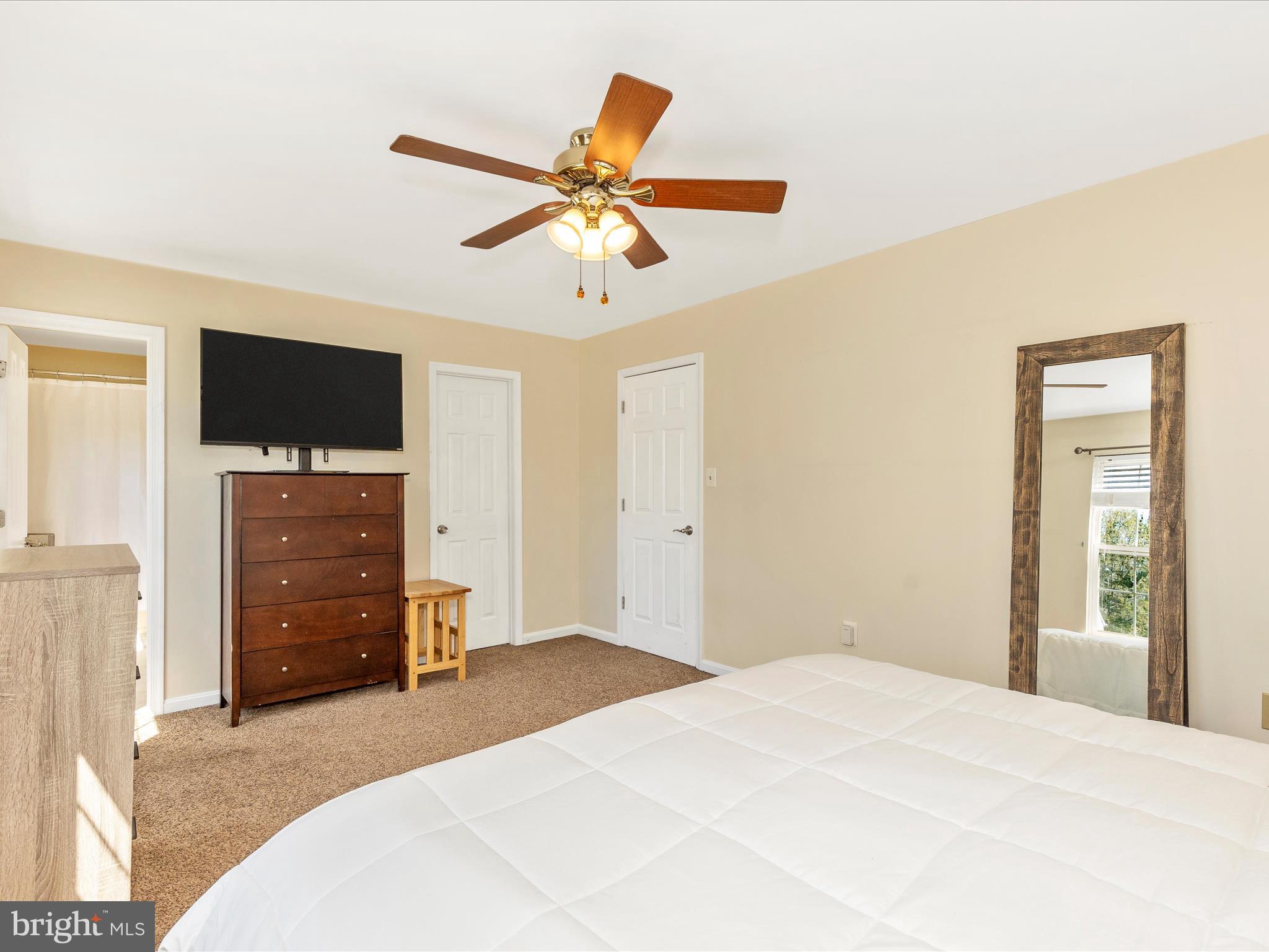 3935 Brittany Lane Hampstead, MD 21074 - Photo 23 of 55 a bedroom with a bed and a flat screen tv