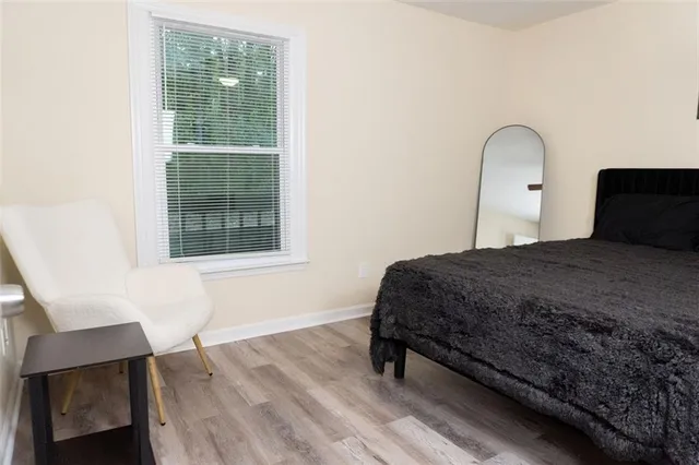 an empty room with wooden floor and a window