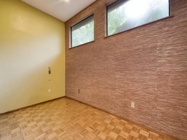 a spacious bedroom with a bed and a large window