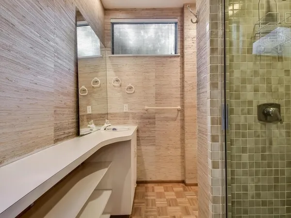 a bathroom with a toilet sink and mirror